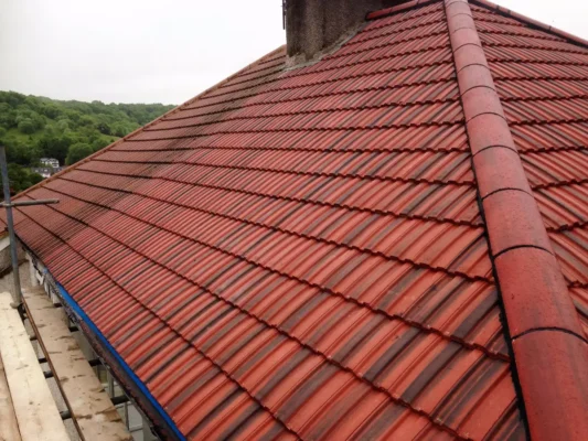 New roof Plymouth installation by Trident Roofing Ltd featuring high-quality red concrete tiles on a residential home.